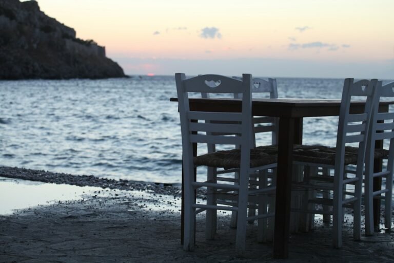 Table and chairs on a beach beside the sea